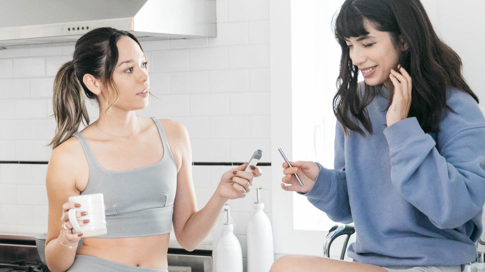 Two people in a shared kitchen holding personal smoke filters