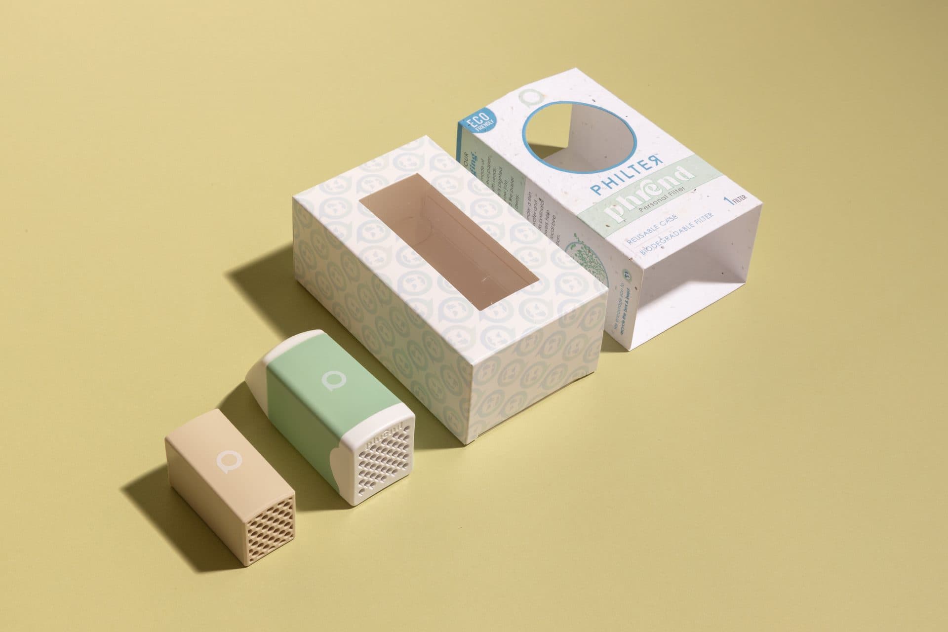PHREND box with the reusable device and replacement cartridges on a yellow background