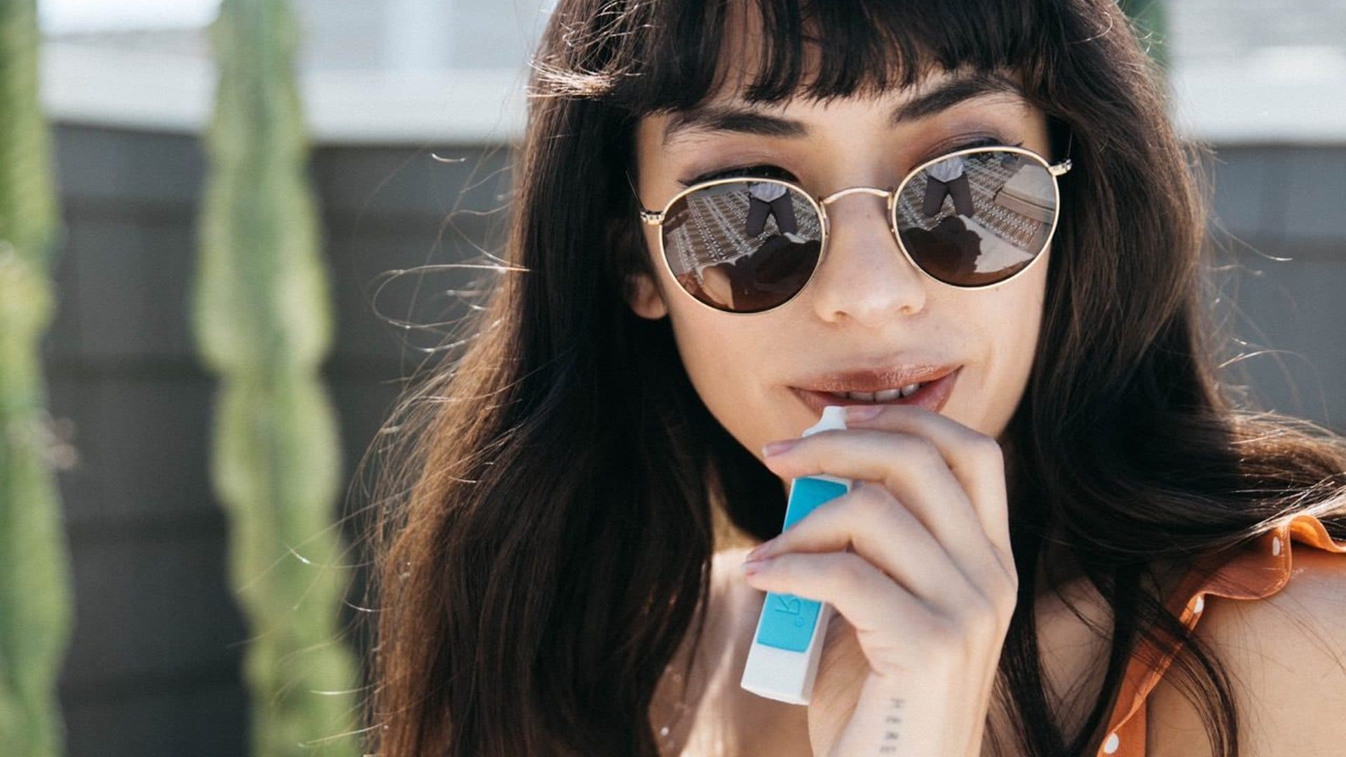 Person exhaling through a POCKET personal smoke filter outdoors